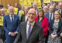 John Swinney with party supporters and fellow MSPs after a press conference at the Grassmarket Community Project in Edinburgh
