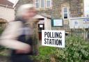 A voter walks past a polling station in London at the English local elections on Thursday