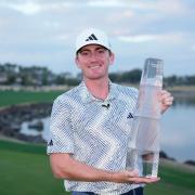 Nick Dunlap holds the trophy after winning the American Express golf tournament (Ryan Sun/AP)