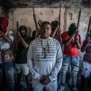 Gang Leader Jimmy 'Barbecue' Cherizier with G-9 federation gang members in the Delmas 3 area on February 22, 2024 in Port-au-Prince, Haiti