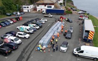 People collecting bottled water at Freshwater car park in Brixham