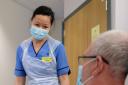 Covid patient Alan Jackson, 61, from Rutherglen, a limousine driver, being watched by nurse Hathi Pham, in the Acute Receiving Unit, The Queen Elizabeth University Hospital, Glasgow, Scotland, dealing with a mixture of Covid and non-covid patient in