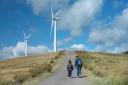 Two brothers walking on path at windfarm in Scotland
