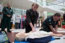 Health secretary Shona Robison demonstrates CPR techniques at the campaign launch