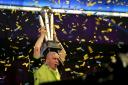 Michael Van Gerwen celebrates with the trophy after winning the final during day sixteen of the William Hill World Darts Championships at Alexandra Palace, London. PRESS ASSOCIATION Photo. Picture date: Tuesday January 1, 2019. Photo credit should read: S