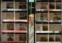 A woman looks at properties for sale in an estate agents - Photograph By Colin Mearns.