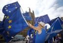 Anti-Brexit demonstrators wave European Union flags outside the Houses of Parliament in London