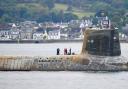 A Royal Navy Vanguard class nuclear submarine returning to Faslane seen covered in sea growth and with missing exterior tiles