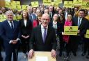 John Swinney poses with supporters as he launches his SNP leadership bid on May 2, 2024