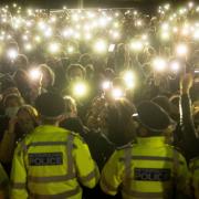 People in the crowd turned on their phone torches as they gathered in Clapham Common, London, for a vigil for Sarah Everard. Photo: PA