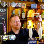 Andrew Black behind the bar at the Commercial Inn, which has just been named Scottish pub of the year by the Campaign for Real Ale (CAMRA). Photo: Jim Payne.