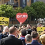 Supporters hold placards as they attend the final general election campaign rally of Scotland's First Minister and leader of the Scottish National Party Nicola Sturgeon in 2017