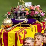 Queen Elizabeth's coffin is carried by pallbearers as part of her funeral procession