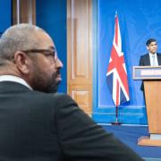 Home Secretary James Cleverly watches Rishi Sunak give a press conference in Downing Street