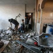 eople inspect the damage to their homes following Israeli air strikes