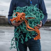 Ally Mitchel from Ocean Plastic Pots holding reclaimed fishing net