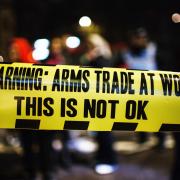 Detail of a banner held by anti-arms trade activists during a demonstration outside the annual black-tie dinner of the Aerospace, Defence and Security Group at the Grosvenor House Hotel on Park Lane in London
