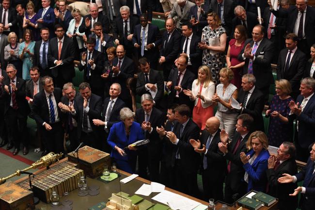 Theresa May received a standing ovation from both the Tories and Liberal Democrats. Photograph: Jessica Taylor