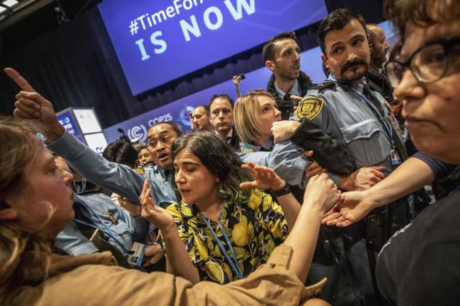 Demonstrators scuffle with UN security staff members during a protest at the COP25 summit in Madrid