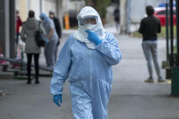 The National: A health worker wears a protective suit at the infectious disease clinic in Zagreb, where the first coronavirus case in Croatia is being treated