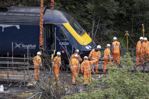 A carriage is lifted by crane from the site of the Stonehaven rail crash as work continues at the scene in Aberdeenshire, following the derailment of the ScotRail train which cost the lives of three people on Wednesday August 12. PA Photo. Picture date: T