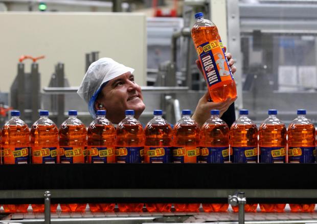 The National: File photo dated 09/09/11 of Mark Jephcott with bottles of Irn Bru as maker  AG Barr shrugged off the freezing start to the year and intense competition to report market-beating sales growth. PRESS ASSOCIATION Photo. Issue date: Tuesday May 28, 2013. See 