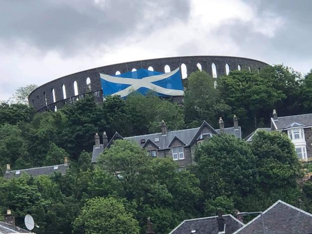 The National: A huge saltire flies from McCaig's Folly in Oban