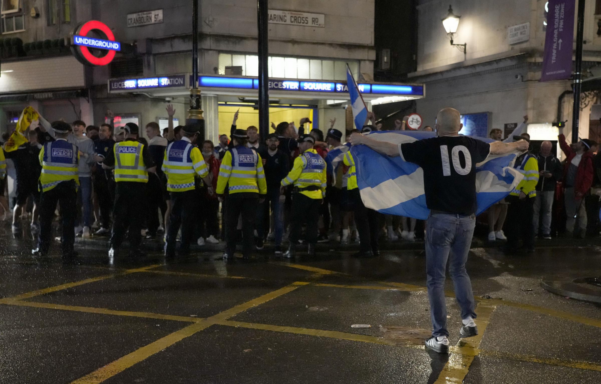 A Scotland supporter reacts outside Leicester Square tube station in London, Friday, June 18, 2021 after the Euro 2020 soccer championship group D match between England and Scotland at Wembley Stadium. The match ended in a 0-0 draw. (AP Photo/Kirsty