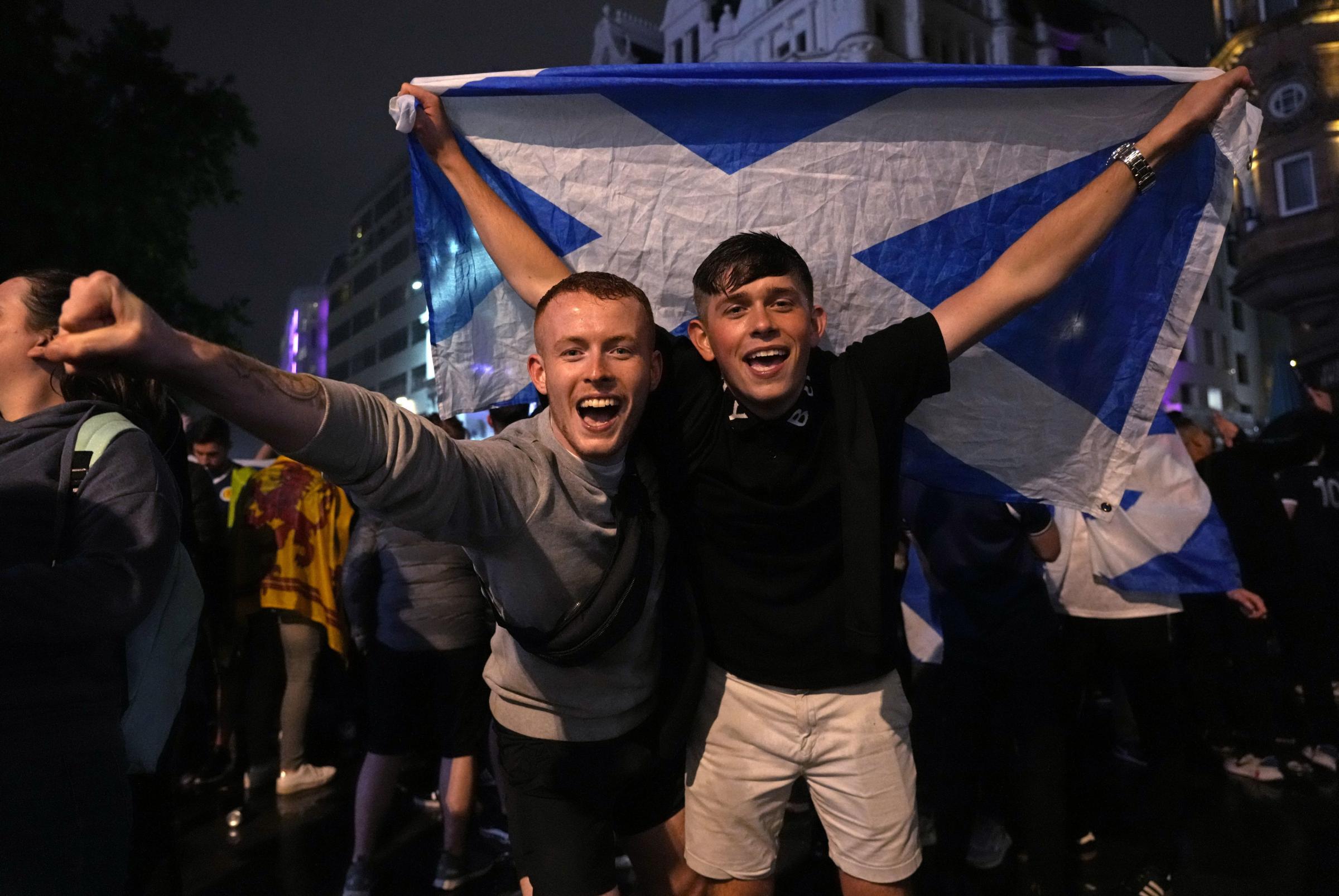 Scotland supporters react in Leicester Square in London, Friday, June 18, 2021 after the Euro 2020 soccer championship group D match between England and Scotland at Wembley Stadium. The match ended in a 0-0 draw. (AP Photo/Kirsty Wigglesworth).
