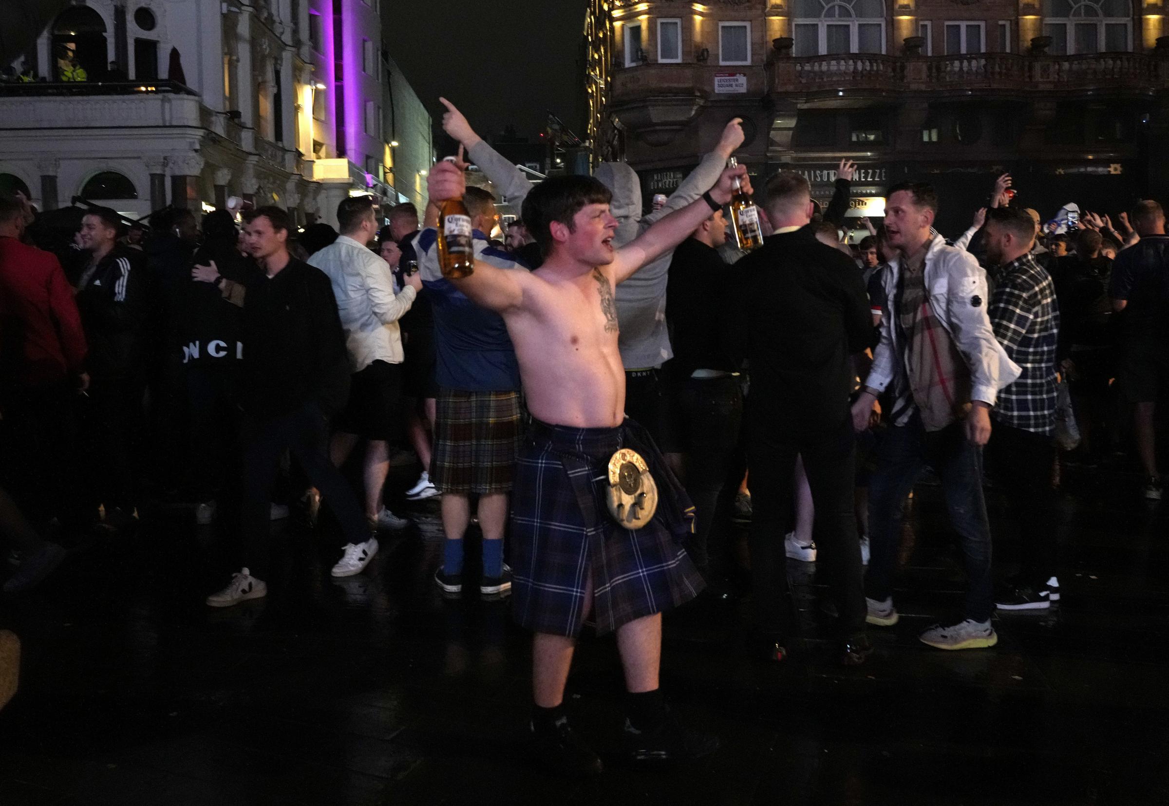 A Scotland supporter reacts in Leicester Square in London, Friday, June 18, 2021 after the Euro 2020 soccer championship group D match between England and Scotland at Wembley Stadium. The match ended in a 0-0 draw. (AP Photo/Kirsty Wigglesworth).