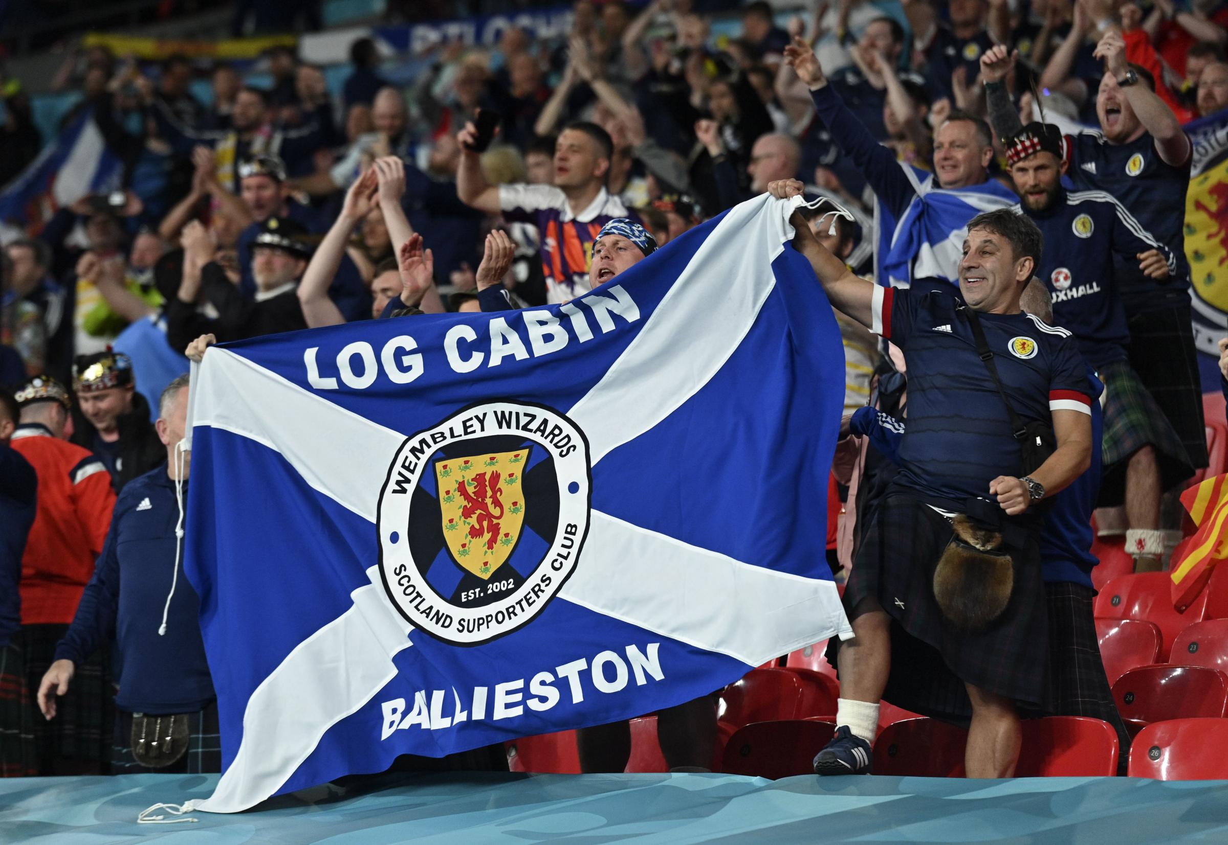 Scotland fans celebrate after the Euro 2020 soccer championship group D match between England and Scotland at Wembley stadium in London, Friday, June 18, 2021. (Justin Tallis/Pool via AP).