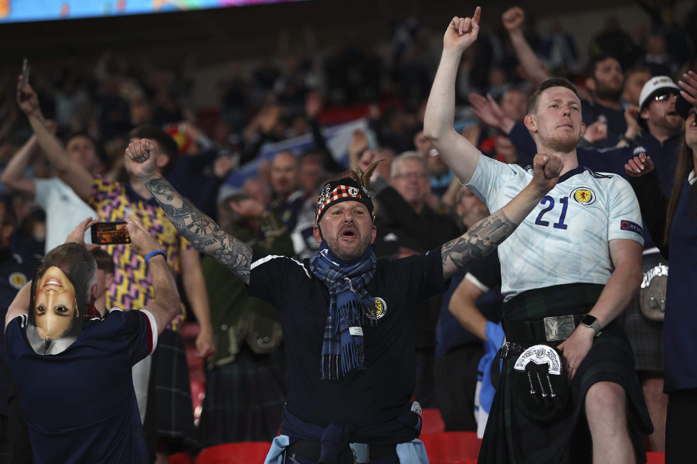Scotland supporters celebrate at the end of the Euro 2020 soccer championship group D match between England and Scotland at Wembley stadium in London, Friday, June 18, 2021. (Carl Recine/Pool Photo via AP).