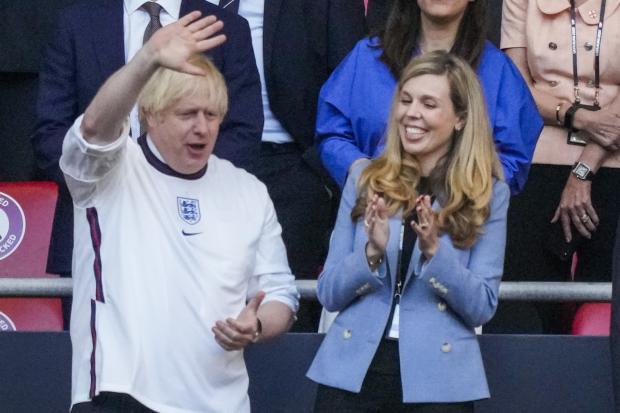 The National: Prime Minister Boris Johnson and his wife Carrie look from the stands before the Euro 2020 semifinal match between England and Denmark at Wembley  Picture: AP Photo/Frank Augstein