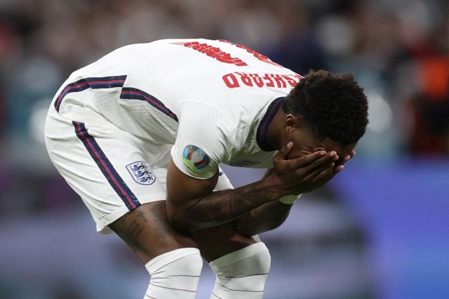 Marcus Rashford reacts after failing to score during England's penalty shoot-out with Italy. He and teammates Jadon Sancho and Bukayo Saka were racially abused afterwards.