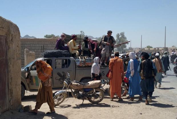 The National: Taliban fighters patrol inside the city of Farah, capital of Farah province, southwest Afghanistan