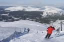 Skiers and snow boarders on the M2 run at the Cairngorm ski area, Aviemore
