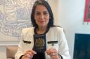 Priti Patel holding one of the blue passports which will be rolled out next month