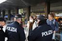Police officers check people at the Venice Santa Lucia railway station, to make sure that they are not violating the quarantine