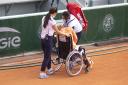 Kiki Bertens leaves the court in a wheelchair