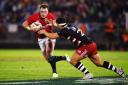 Scotland's Stuart Hogg (left) rides a challenge while playing for the Lions