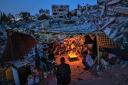 GAZA CITY, GAZA - MAY 25: Palestinian children hold candles during a rally amid the ruins of houses destroyed by Israeli strikes, in Beit Lahia Northern Gaza Strip on May 25, 2021 in Gaza City, Gaza. Gaza residents returned to  damaged and destroyed