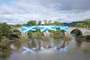 Independence supporters hang Saltires over the Auld Brig at Bannockburn during an All Under One Banner march in 2021