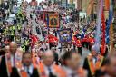 An Orange Order march that would have passed two Catholic churches has been re-routed 'voluntarily' by organisers