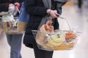 Undated file photo of a woman shopping holding a basket. UK grocery sales have tumbled by 4% over the past three months as shoppers continue to return steadily to pre-pandemic habits, according to figures. Data firm Kantar founded that sales declined for