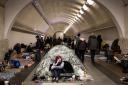 A woman takes shelter in Dorohozhychi Metro station in Kyiv  as the shelling of the capital intenifies
