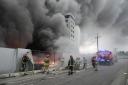 Firefighters work to extinguish a fire at a damaged logistic centre after shelling in Kyiv