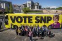 First Minister Nicola Sturgeon with SNP candidates and party supporters alongside the campaign bus at Holyrood, Edinburgh, while on the local election campaign trail.