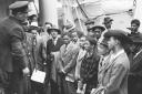 File photo dated 22/06/48 of Jamaican immigrants welcomed by RAF officials after ex-troopship HMT Empire Windrush landed them at Tilbury