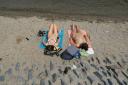 Sunbathers at Loch Lomond, at the village of Luss in Argyll and Bute as a heatwave scorches the UK