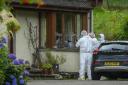 Forensics officers working at the MacKenzie’s cottage home, scene of a firearm incident in the Dornie area of Wester Ross on Wednesday